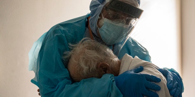 HOUSTON: Dr. Joseph Varon kisses and comforts a COVID-19 intensive care unit (ICU) patient during Thanksgiving at the United Memorial Medical Center on November 26, 2020 in Houston, Texas.  According to reports, Texas has reached more than 1,220,000 cases, including more than 21,500 deaths.  (Photo by Go Nakamura / Getty Images)