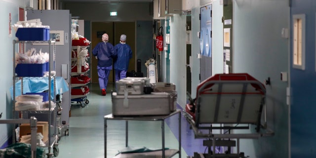Medics walk along a corridor at Bichat Hospital, AP-HP, in Paris.