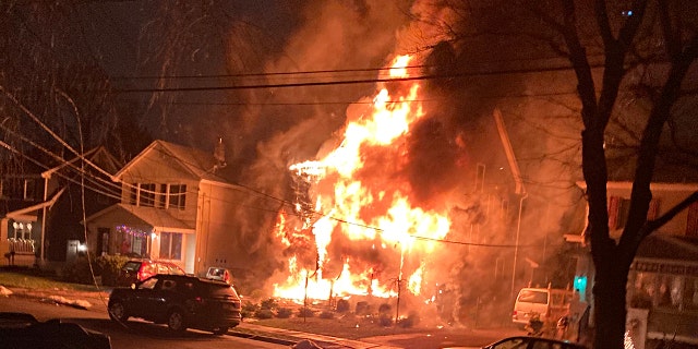 The Mojica's home in Metuchen, N.J. engulfed in flames.