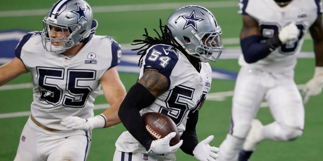 Dallas Cowboys linebacker Jaylon Smith (54) returns a Washington Football Team's Alex Smith interception for a long gain as Leighton Vander Esch (55) provides a block in the second half of an NFL football game in Arlington, Texas, Thursday, Nov. 26, 2020. (AP Photo/Ron Jenkins)