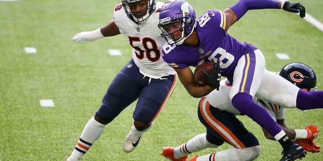 Minnesota Vikings wide receiver Justin Jefferson (18) is tackled by Chicago Bears linebacker Roquan Smith (58) and safety Eddie Jackson, right, after catching a pass during the first half of an NFL football game, Sunday, Dec. 20, 2020, in Minneapolis. (AP Photo/Bruce Kluckhohn)