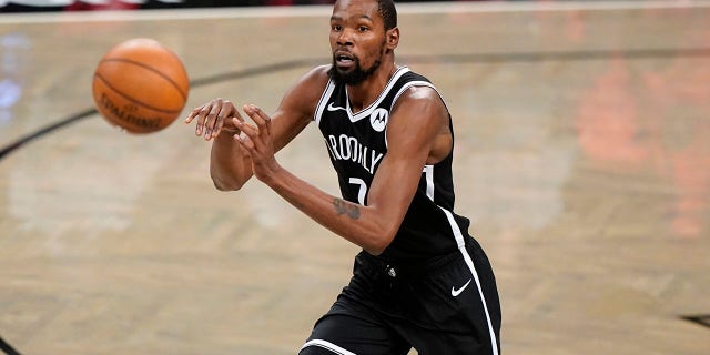 Brooklyn Nets forward Kevin Durant passes during the first half of a preseason game against the Washington Wizards Dec. 13, 2020, in New York.