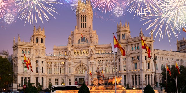 Fountain of the Cibeles and Palace of Communication, Culture and Citizenship Centre in the Cibeles Square of Madrid with fireworks