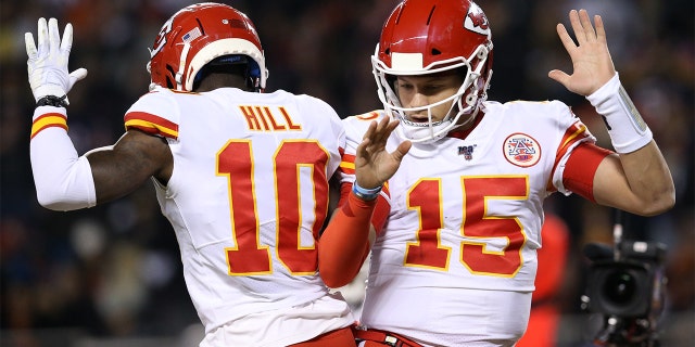 CHICAGO, ILLINOIS - DECEMBER 22: Quarterback Patrick Mahomes #15 of the Kansas City Chiefs celebrates with teammate wide receiver Tyreek Hill #10 after scoring a touchdown against the Chicago Bears in the first quarter of the game at Soldier Field on December 22, 2019 in Chicago, Illinois. (Photo by Dylan Buell/Getty Images)
