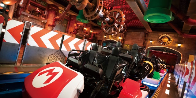 Guests can travel through iconic Mario Kart courses with the interactive roller coaster.
