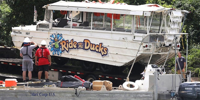 The duck boat is hauled out of the water on July 23, 2018, at Table Rock Lake in Branson, Mo. A federal judge dismissed charges against three people connected to the incident. (J.B. Forbes/St. Louis Post-Dispatch/Tribune News Service via Getty Images)