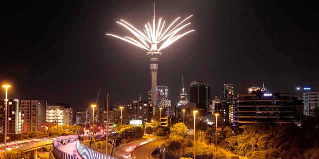 Fireworks are launched from the Sky Tower to mark the changing of the year on New Year's eve in Auckland, New Zealand, Thursday, Dec. 31, 2020. New Zealand and its South Pacific island neighbors have no COVID-19, and New Year celebrations there are the same as ever. (Michael Craig/NZ Herald via AP)