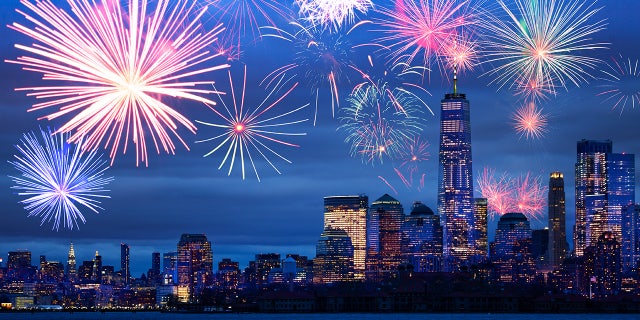 Night time fireworks celebration over Hudson harbor to New York panorama view