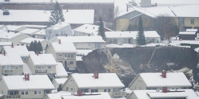 A massive landslide struck the small Norwegian town of Ask Wednesday morning around 4 a.m., leaving 10 people injured and nearly two dozen unaccounted for. (Fredrik Hagen/NTB via AP)