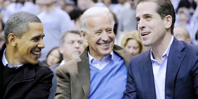 President-elect Joe Biden with his son, Hunter, at a college basketball game in Washington in 2010. The U.S. Attorney's Office in Delaware is investigating the younger Biden's taxes. (AP Photo/Nick Wass, File)