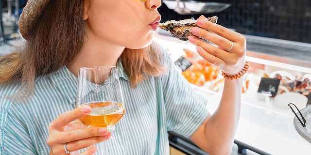 woman eating at outdoor restaurant