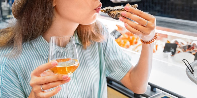 woman eating at outdoor restaurant