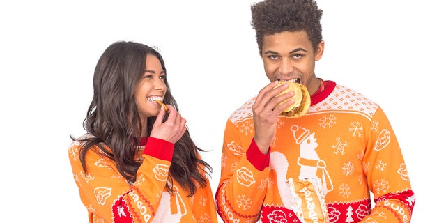 It is not a requirement to eat a chicken sandwich while wearing a Popeyes sweater. But it does look fun.