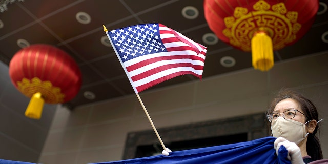 A protester holds a U.S. flag outside the Chinese consulate in Houston, Julie 24, 2020, after the U.S. State Department ordered China to close the consulate. (Getty Images)