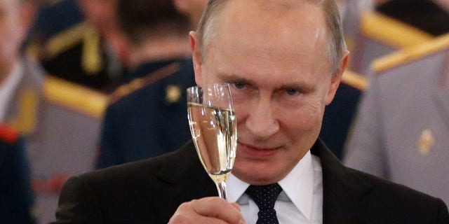 Russian President Vladimir Putin toasts during reception for military servicemen who took part in Syrian campaign, at Grand Kremlin Palace on December 28, 2017, in Moscow, Russia.
