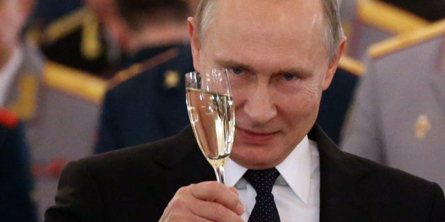 Russian President Vladimir Putin toasts during reception for military servicemen who took part in Syrian campaign, at Grand Kremlin Palace on Dec. 28, 2017 in Moscow, Russia. (Photo by Mikhail Svetlov/Getty Images)