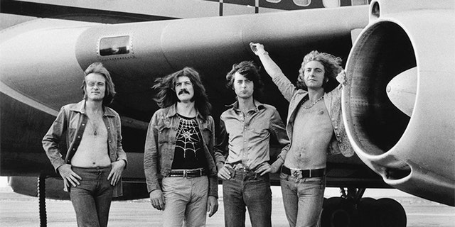 (L-R) John Paul Jones, John Bonham, Jimmy Page and Robert Plant of Led Zeppelin in front of a plane in NY. July 24, 1973.
