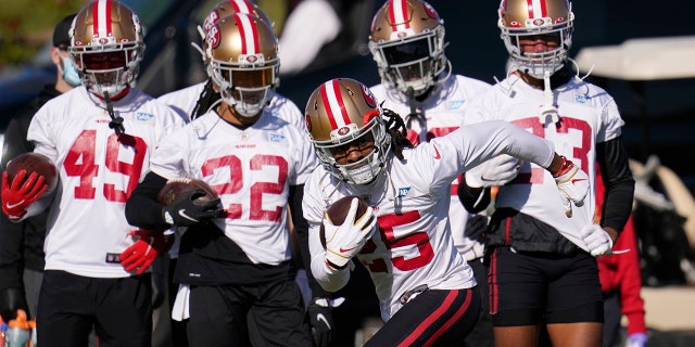 San Francisco 49ers cornerback Richard Sherman takes off with the ball during NFL football practice near State Farm Stadium, home of the Arizona Cardinals, Thursday, Dec. 3, 2020, in Glendale, Ariz. The 49ers are on a three-week road trip after being forced from their stadium and practice facility because of strict new COVID-19 protocols in their home county in Northern California. (AP Photo/Ross D. Franklin)