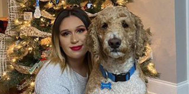 Sarah Simental posing for a Christmas photo with her dog. 