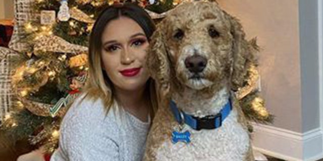 Sarah Simental posing for a Christmas photo with her dog. 