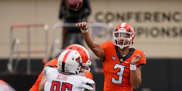 Oklahoma State quarterback Spencer Sanders (3) throws under pressure from Texas Tech defensive lineman Philip Blidi (96) in the first half of an NCAA college football game in Stillwater, Okla., Saturday, Nov. 28, 2020. (AP Photo/Sue Ogrocki)