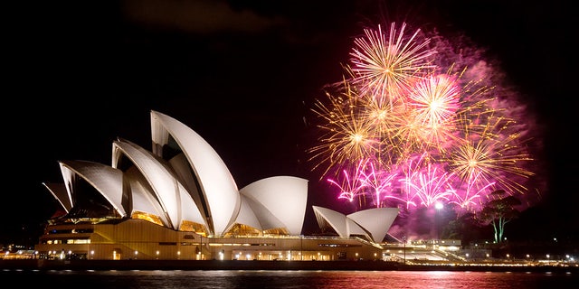 Sydney, Australia - April 9, 2014: Fireworks erupt behind the Sydney Opera House at night, as part of a Madama Butterfly opera being staged on Sydney Harbour.