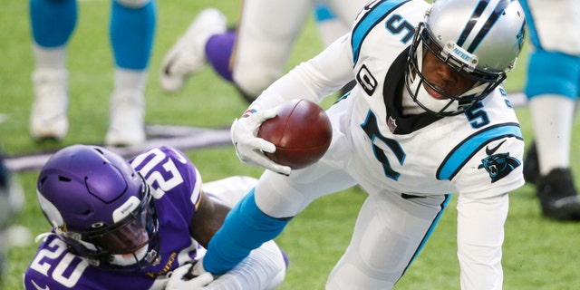 Carolina Panthers quarterback Teddy Bridgewater (5) tries to break a tackle by Minnesota Vikings cornerback Jeff Gladney (20) during the second half of an NFL football game, Sunday, Nov. 29, 2020, in Minneapolis. (AP Photo/Bruce Kluckhohn)