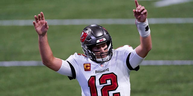 Tampa Bay Buccaneers quarterback Tom Brady (12) reacts after a Tampa Bay Buccaneers touchdown against the Atlanta Falcons during the second half of an NFL football game, Sunday, Dec. 20, 2020, in Atlanta. (AP Photo/John Bazemore)