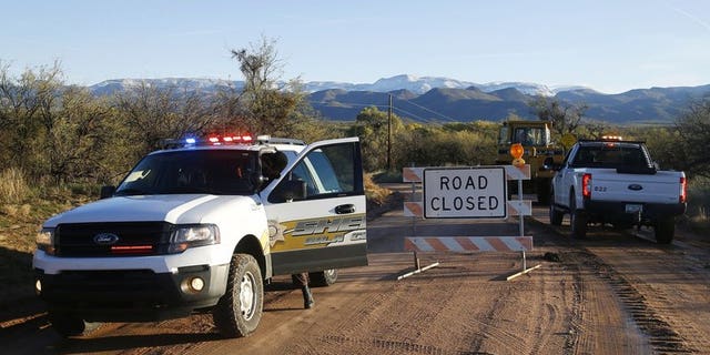 The road closed near Bar X road and Tonto Creek after a vehicle was washed by flood waters in Tonto Basin, Ariz. (Patrick Breen/The Arizona Republic via AP,File)