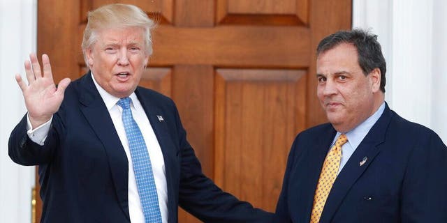 Then President-elect Donald Trump waves to the media as Gov. Chris Christie arrives at the Trump National Golf Club Bedminster clubhouse in New Jersey on Nov. 20, 2016.