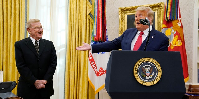 President Donald Trump prepares to bestow the Medal of Freedom, the highest civilian honor, to former college football coach Lou Holtz at the White House on Thursday, December 3, 2020, in Washington.  Holtz had a rich 34-year coaching career, which included winning the national title in 1988 at the University of Notre Dame.  (AP Photo / Evan Vucci)