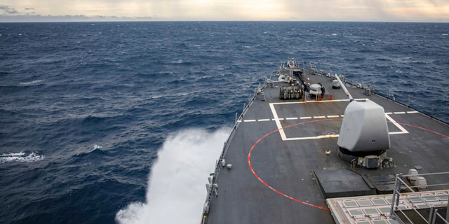 The USS John S. McCain transits through the South China Sea while conducting routine underway operations.