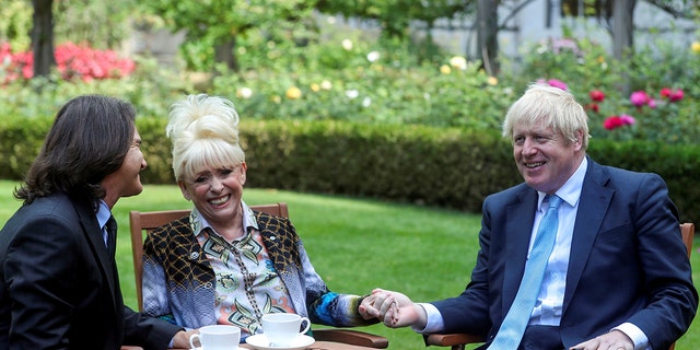 British actress Barbra Windsor, center, meets British Prime Minister Boris Johnson with her husband, Scott Mitchell. Johnson paid tribute to the "EastEnders" star following her death.