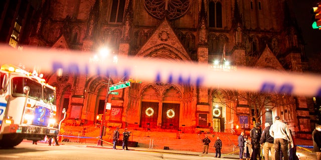 Police are seen outside of the Cathedral of St. John the Divine in New York on December 13, 2020, after a shooter opened fire outside the church. (Photo by Kena Betancur / AFP)