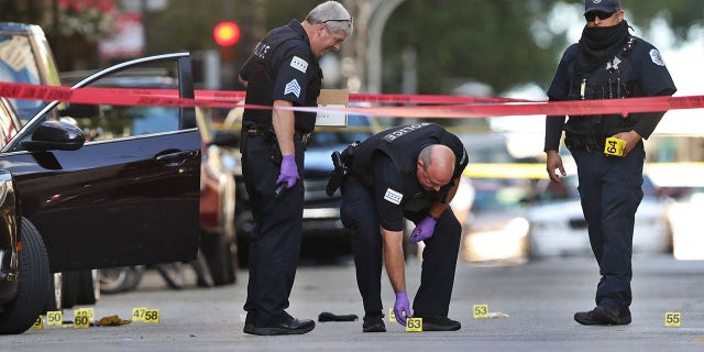 Chicago police investigate the scene of a shooting that killed rapper Carlton Weekly, known as FBG Duck, and wounded two others at 70 E. Oak St. in Chicago on August 4, 2020. (Chris Sweda/Chicago Tribune/Tribune News Service via Getty Images)