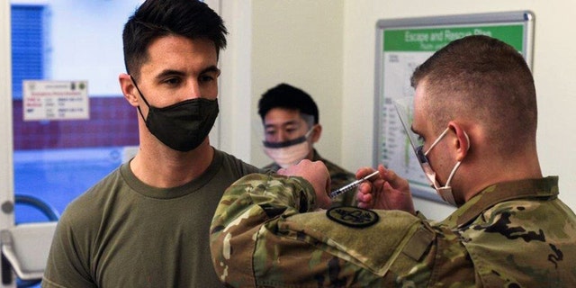U.S. Army Capt. Skyler Brown, family medicine physician assigned to 1st Squadron, 91st Calvary Regiment (Airborne), 173rd Airborne Brigade Combat Team, is first in all U.S. Army Europe and Africa to receive the coronavirus vaccine. (U.S. European Command Public Affairs)