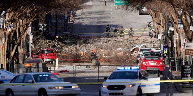 Investigators continue to examine the site of an explosion Sunday, Dec. 27, 2020, in downtown Nashville, Tenn. (AP Photo/Mark Humphrey)