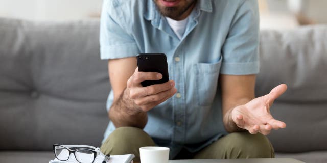 Man composes email on smartphone. 