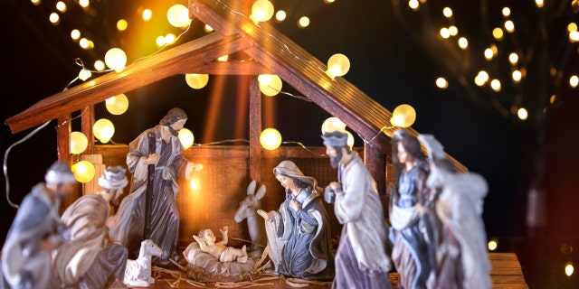 A Christmas manger scene, with figurines including Jesus, Mary, Joseph, sheep and wise men. Jesus' birth, death and resurrection introduced redemptive power into the world.