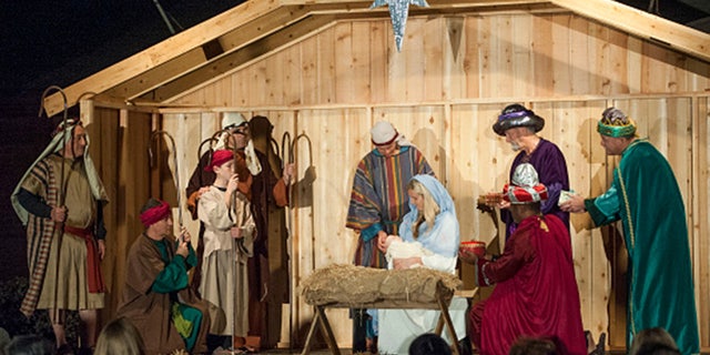 Volunteers portray the nativity scene in front of the Church of Jesus Christ on December 10, 2015 in Fountain Valley, California.