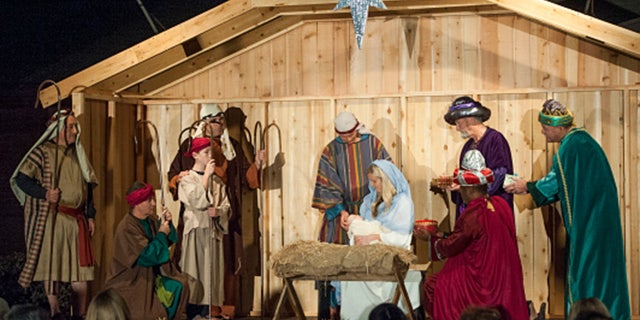 Volunteers portray the Nativity scene outside the Church of Jesus Christ in Fountain Valley, California, on Dec. 10, 2015.
