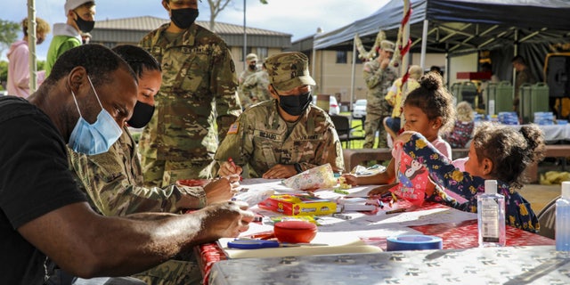 Soldiers and Families with 1st Battalion, 27th Infantry Regiment "Wolfhounds", 2nd Infantry Brigade Combat Team, 25th Infantry Division, create gifts and ornaments to send to the Holy Family Home orphanage on December 4, 2020 at Schofield Barracks, Hawaii. 1-27 IN and the Holy Family Home orphanage in Osaka, Japan, have an enduring relationship dating back to just after World War II, when Soldiers took up a collection for the orphanage during the holiday season in 1949.