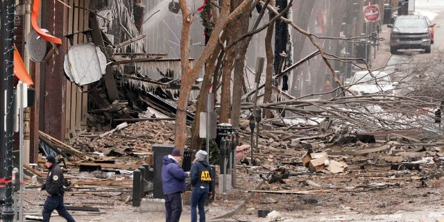 Emergency personnel work near the scene of an explosion in downtown Nashville, Tenn., Friday, Dec. 25, 2020. (AP Photo/Mark Humphrey)