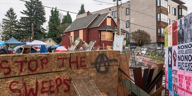 PORTLAND, OR - 09 DECEMBER: Layers of chain fence and wood block access to the Red House in Mississippi Street on December 9, 2020 in Portland, Oregon.  Police in riot gear stormed a rally on Tuesday morning, removing hundreds of protesters by truck.  (Photo by Nathan Howard / Getty Images)