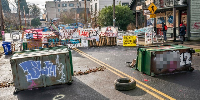 Barriers surround the Red House, whose residents are up for eviction, on December 10, 2020 in Portland, Oregon. Police and protesters clashed during an attempted eviction Tuesday morning, leading protesters to establish a barricade around the Red House. (Photo by Nathan Howard/Getty Images)