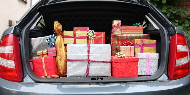 A hatchback car with its boot/trunk stuffed full of Christmas presents prior to visiting relatives on Christmas day.