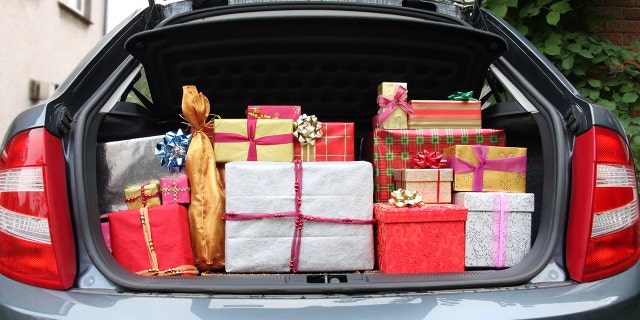 A hatchback car with its boot/trunk stuffed full of Christmas presents prior to visiting relatives on Christmas day.