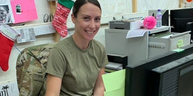 U.S. Army Spc. Anna Schmeck, automated logistical specialist with Headquarters Support Company, 628th Aviation Support Battalion, 28th Expeditionary Combat Aviation Brigade, poses for a photo while at work at a motor pool in the 28th ECAB's area of operations in the Middle East.