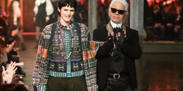 Stella Tennant and Karl Lagerfeld walk the runway at the CHANEL: Metiers d'Art fashion show at Linlithgow Palace on December 4, 2012 in Linlithgow, Scotland.