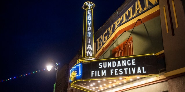 FILE - The marquee of the Egyptian Theatre promotes the 2020 Sundance Film Festival in Park City, Utah on Jan. 28, 2020. Organizers on Wednesday said that this year they will premiere over 70 films on a custom online platform during the seven day event. There will also be some socially distanced screening opportunities around the country.